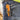 Orange Klein Tools pocket knife in a blue jeans pocket
