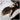 Black and beige gloves on a surface of blueprints