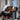 Person wearing a hard hat and orange and black heavy duty klein tools gloves.