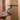 Klein Tools speaker hanging on a pole against a dry wall background