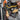 Person working on electrical equipment with a multimeter