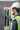 Person in safety gear checking electrical panel with a device