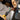 Person wearing gloves and using pliers to work on electrical wiring.