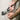 Person using pliers to work with electrical wires on a wall socket.