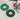 Two green circular plastic spool covers, one green and one black with green accents, shown on a concrete floor next to a green spool stand holding red, white, and yellow wire.