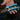 Hand holding a pair of Klein Tools wire strippers against a dark background