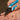 Person using Klein Tools wire strippers on a dark background